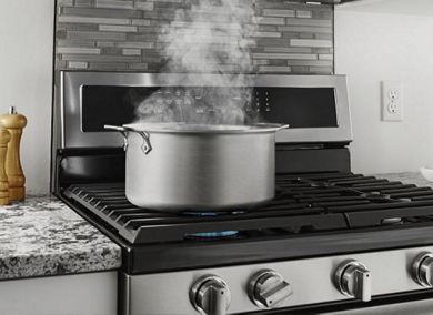 Water boiling on top of a Maytag oven