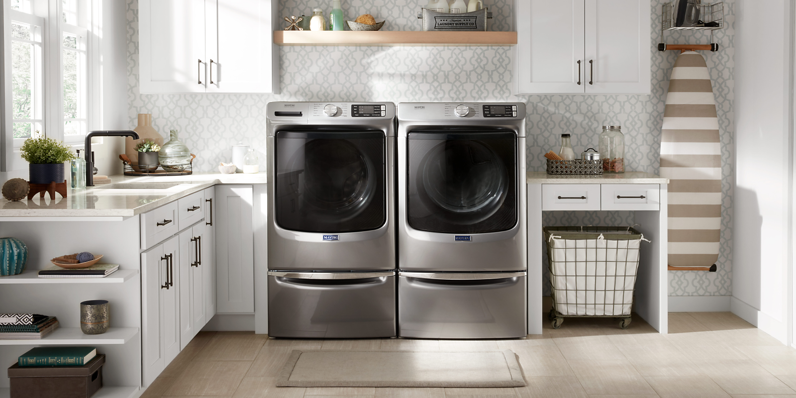 Stainless steel Maytag® washer and dryer in a modern laundry room