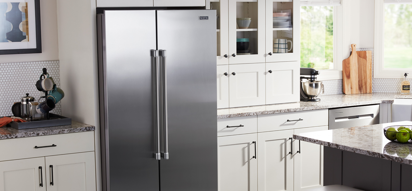Stainless side-by-side refrigerator in a white kitchen