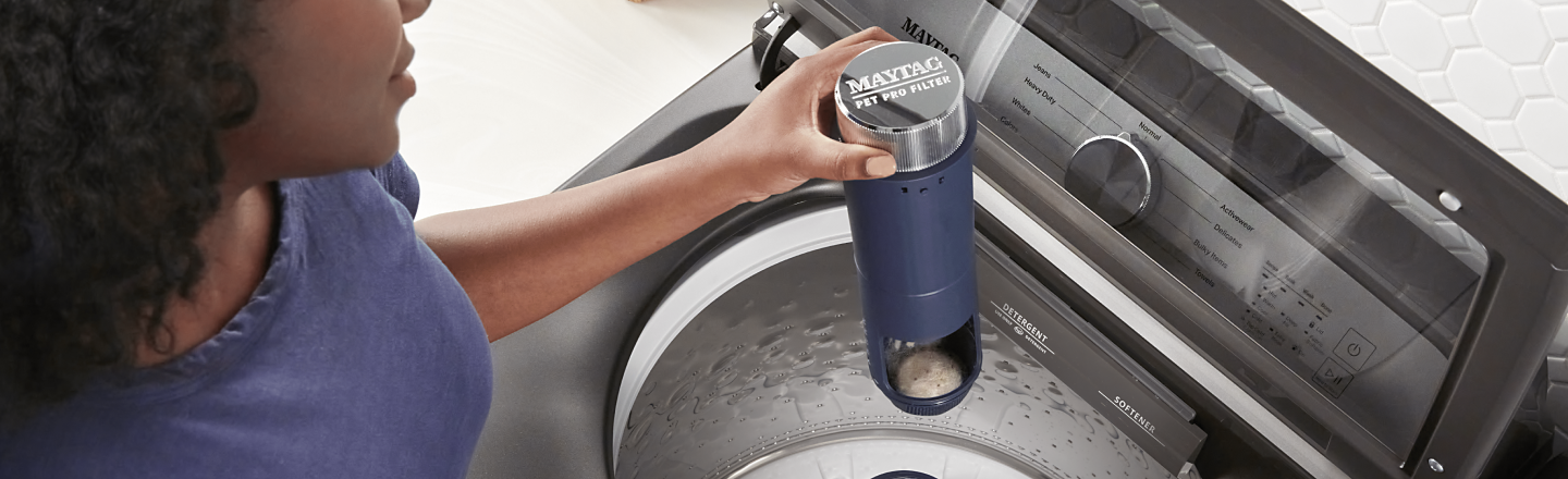 Person holding a Maytag® Pet Pro Filter