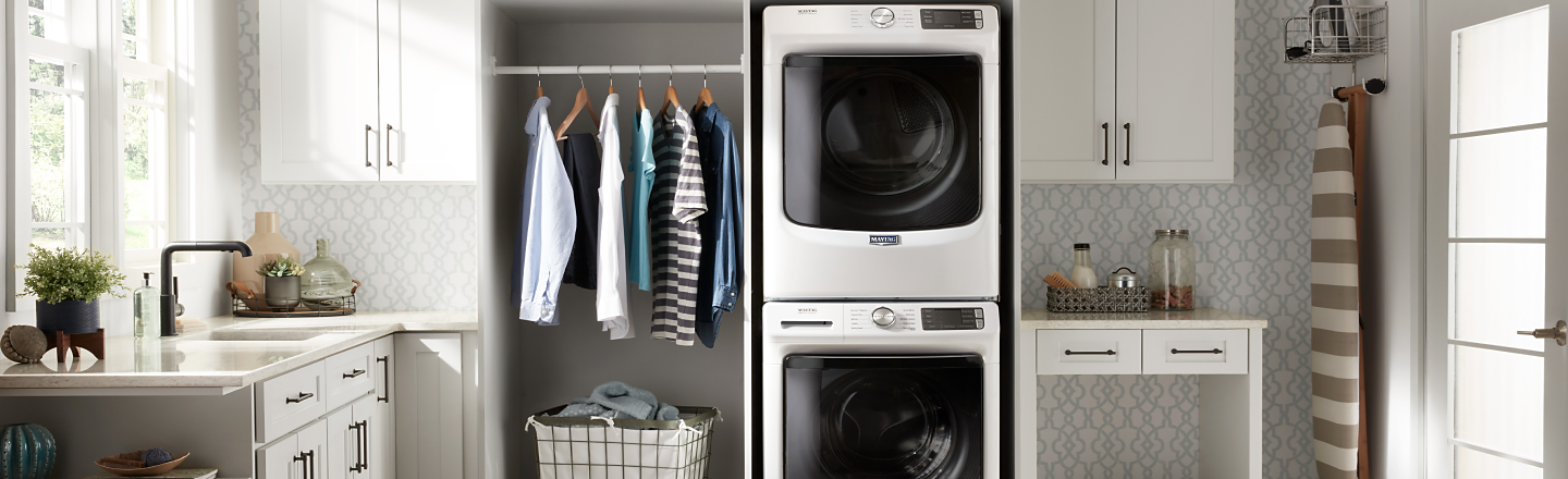 Maytag® stacked washer and dryer in a white laundry room