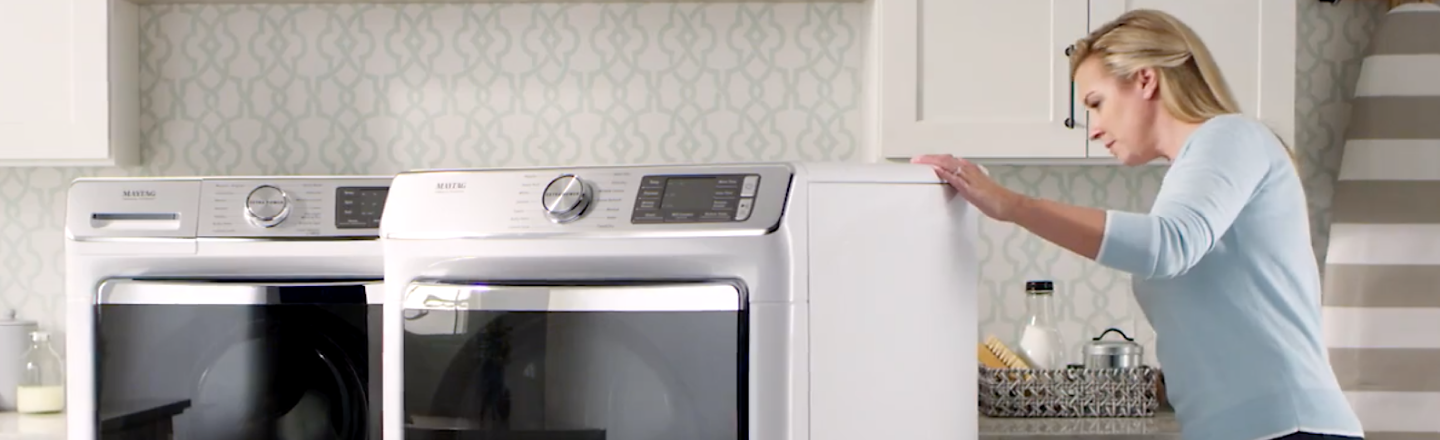 Person looking at a Maytag® washer and dryer