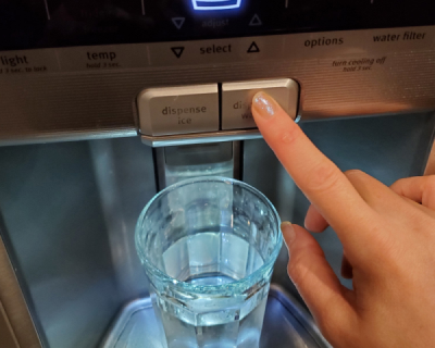  A finger pressing the water button