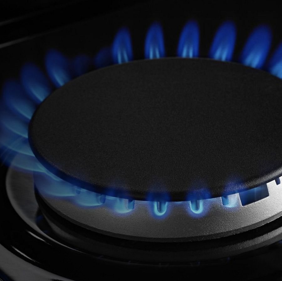 A closeup of a burner on a Maytag® cooktop.