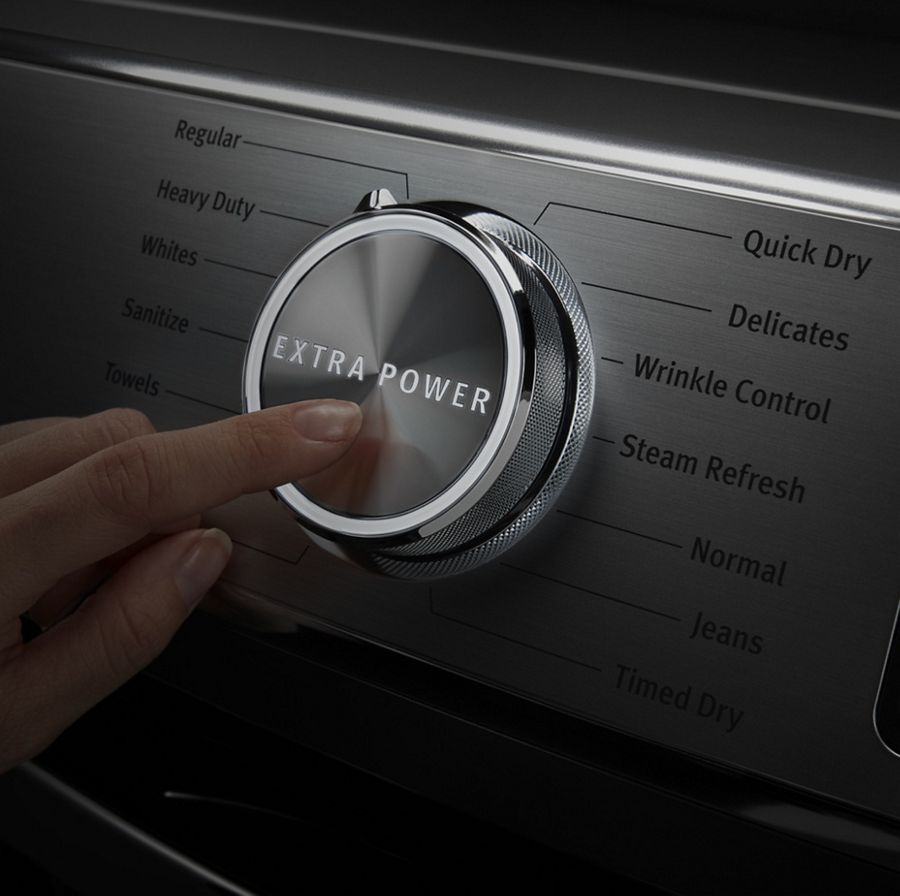 A person pressing the Extra Power button on a Maytag® dryer.