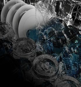 An open Maytag® dishwasher with dishes inside.