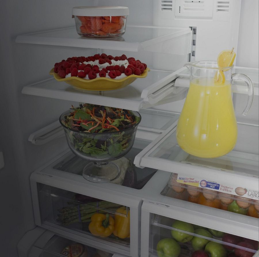 An open Maytag® refrigerator with food inside.