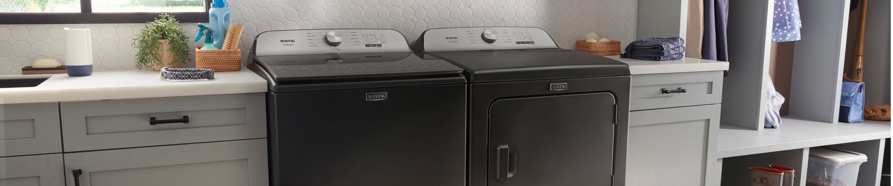 A Maytag® washer and dryer pair in a laundry room.