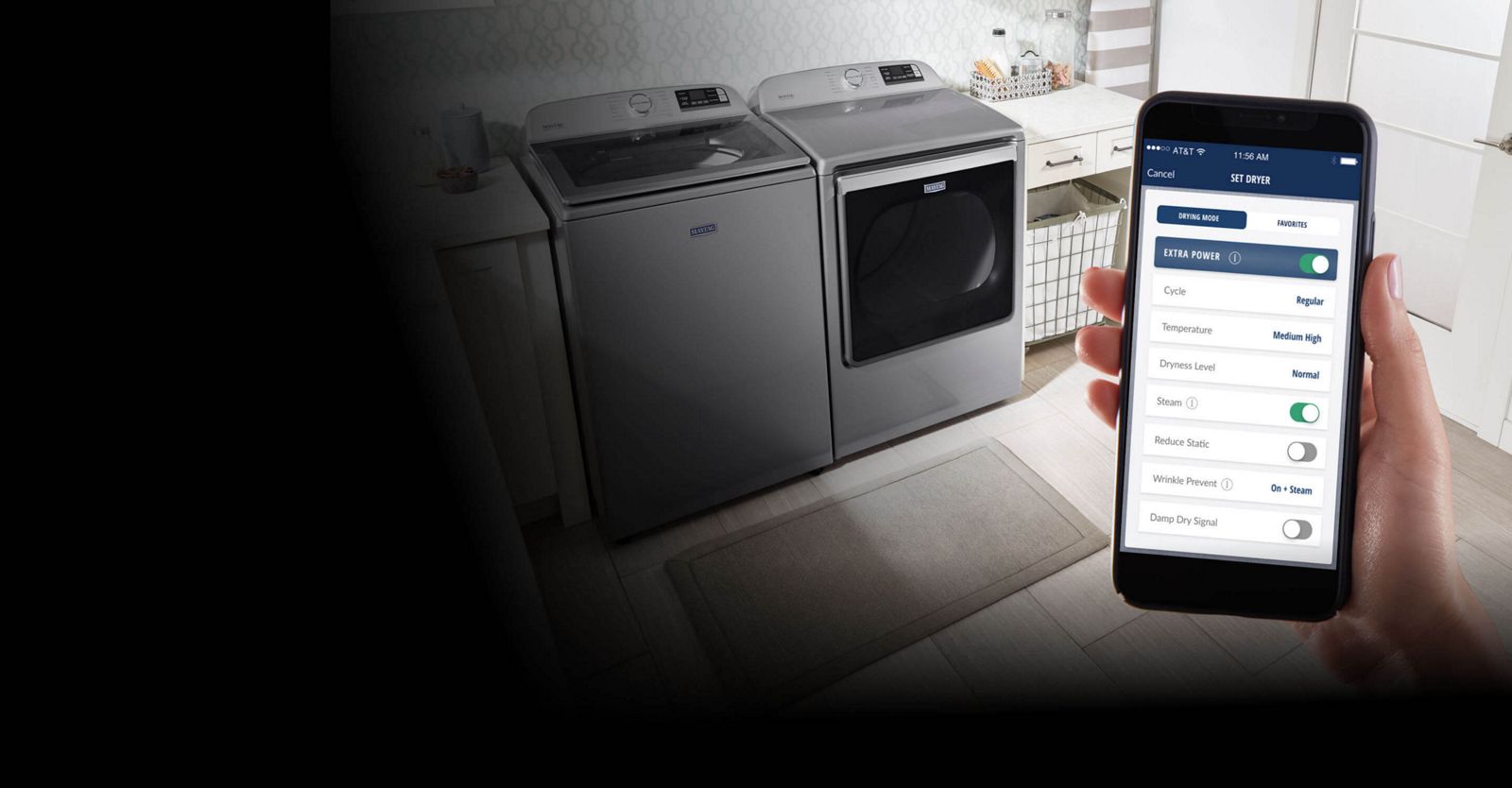 Image of a smartphone displaying the Maytag® app with a washer and dryer in the background.