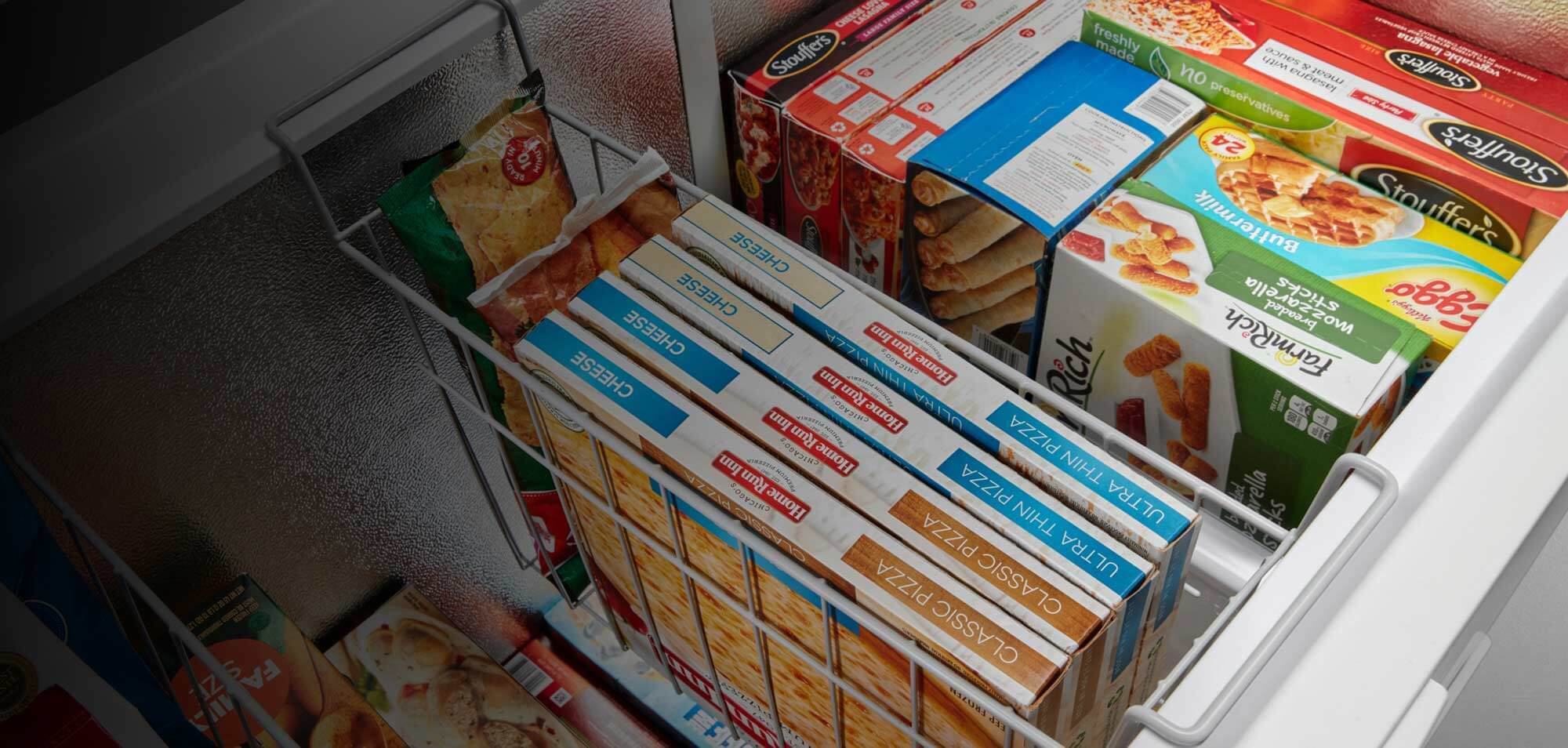 Frozen food inside a Maytag® chest freezer.