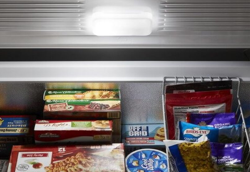 Frozen food in an open Maytag® chest freezer.