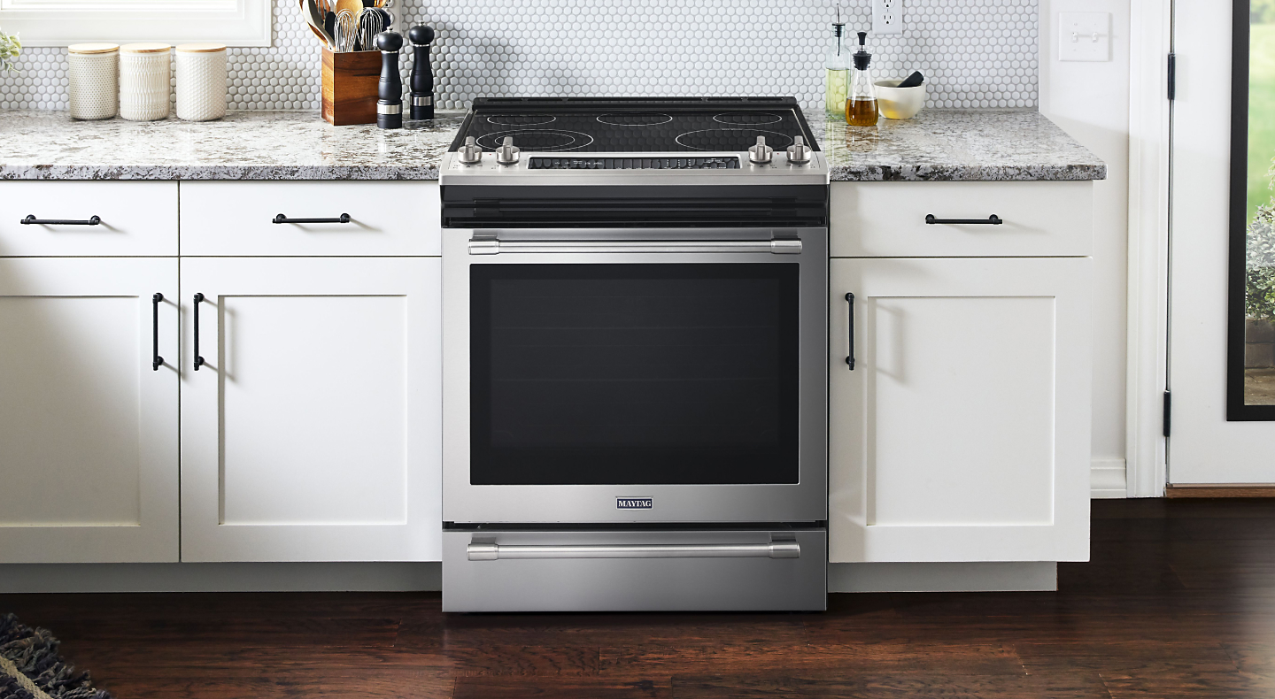 Maytag® electric range set in cabinetry