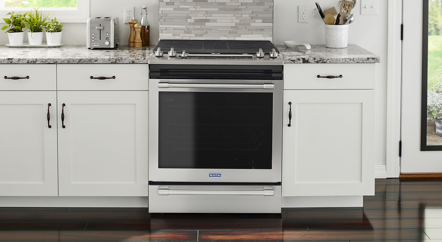 Maytag® gas range set in cabinetry