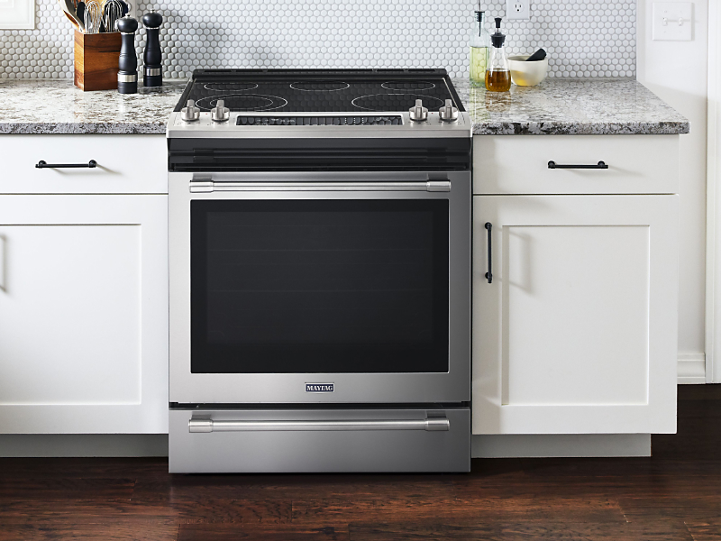 Maytag® electric range set in cabinetry