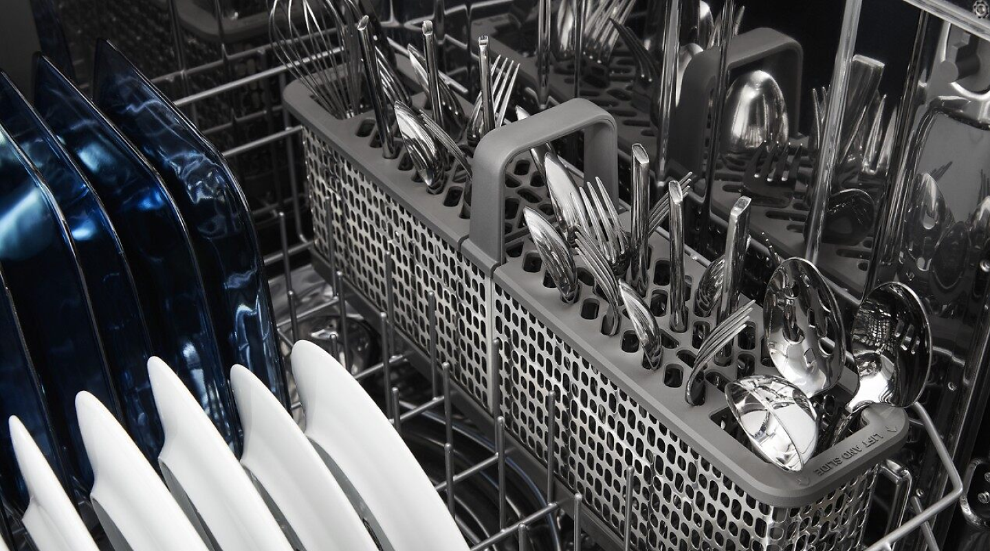 View of dishwasher bottom rack and silverware basket