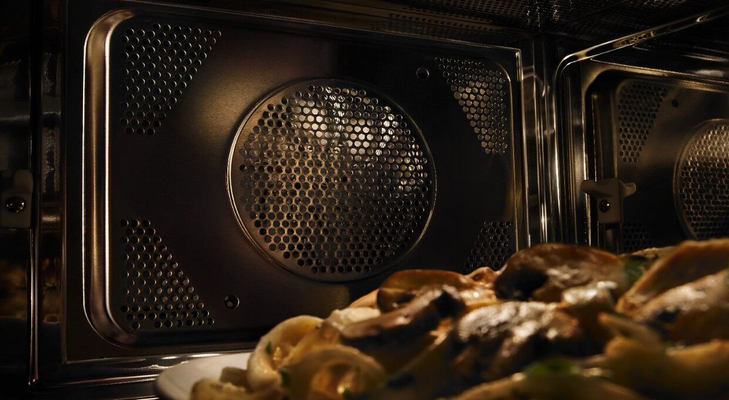 A closeup of the interior of a built-in Maytag® microwave.
