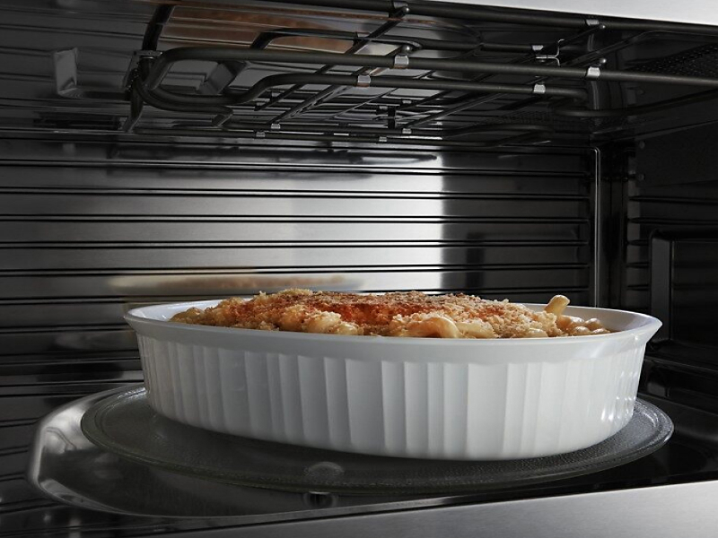  A closeup of the interior of a convection Maytag® microwave cooking a pasta meal.