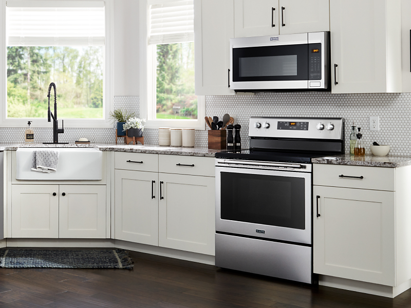Maytag® microwave hood combination over Maytag® range in white kitchen