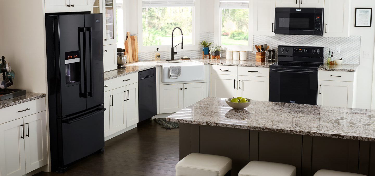 Black Maytag® appliances in a white kitchen