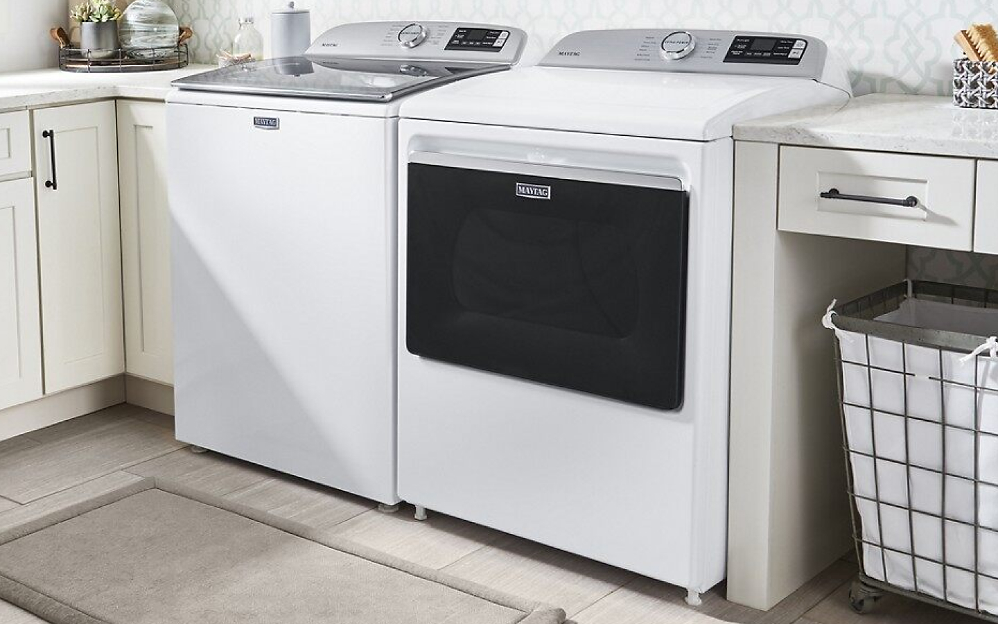White MaytagⓇ top-load washer and dryer pair in white cabinetry