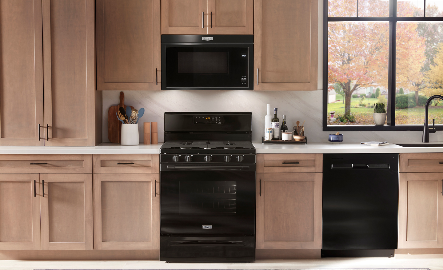 A Maytag® stove and over-the-range microwave in a modern kitchen