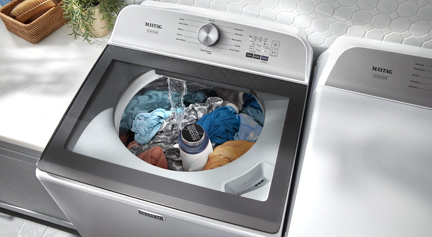 Birds-eye view of the Maytag® Top Load Pet Pro washer with clothing inside