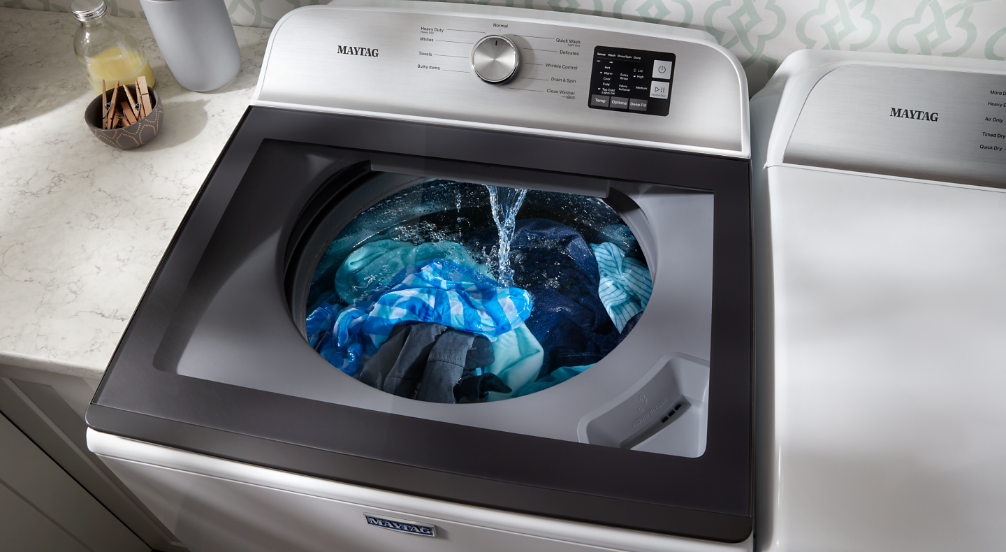 Top loading Maytag® washing machine washing a load of laundry