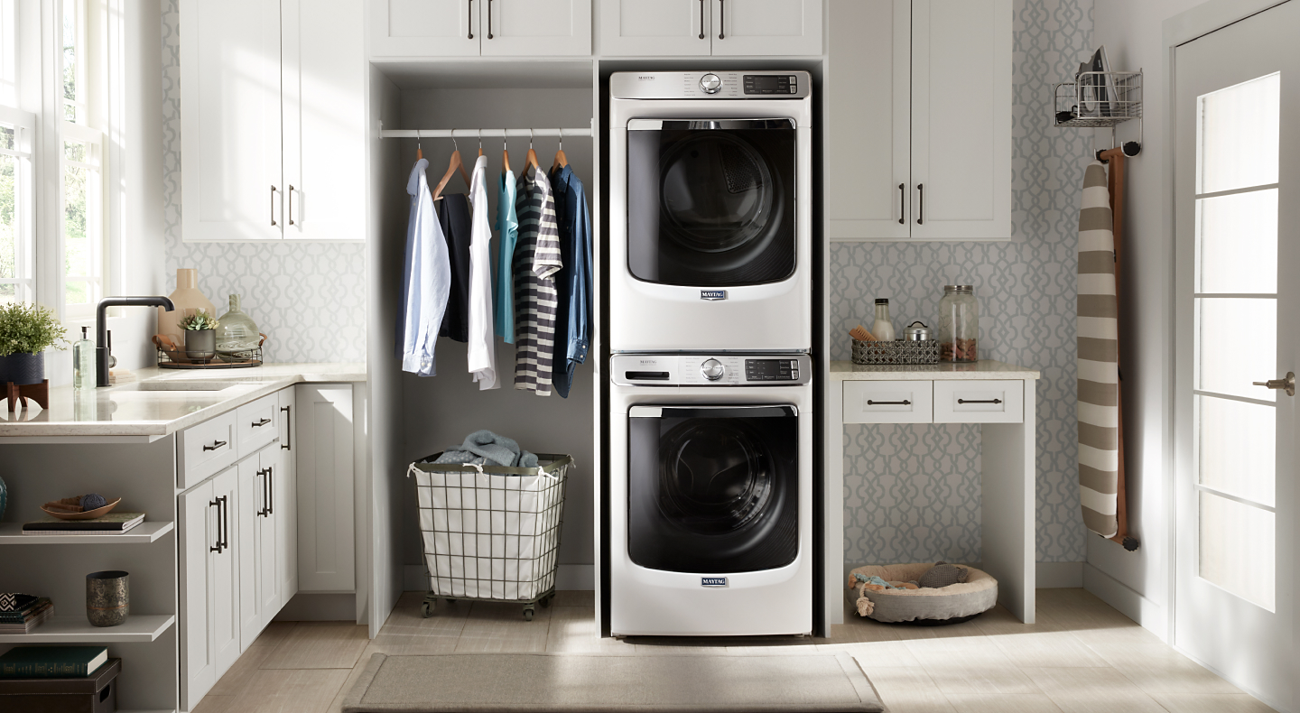 Stacked front loading Maytag® washer and dryer in a laundry room