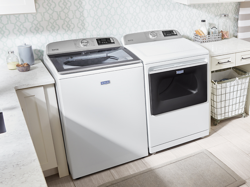 White Maytag® washer and dryer in a laundry room