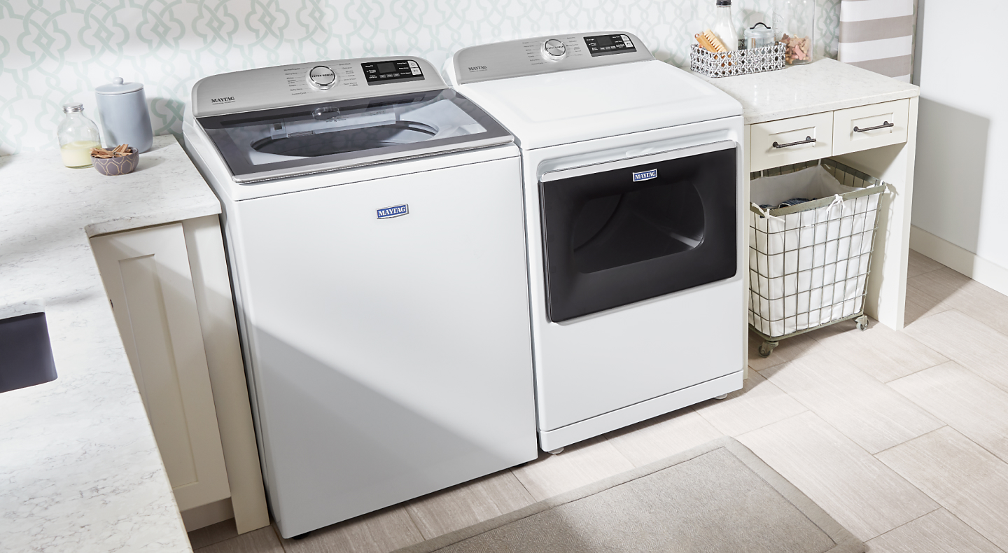 White Maytag® washer and dryer in a laundry room