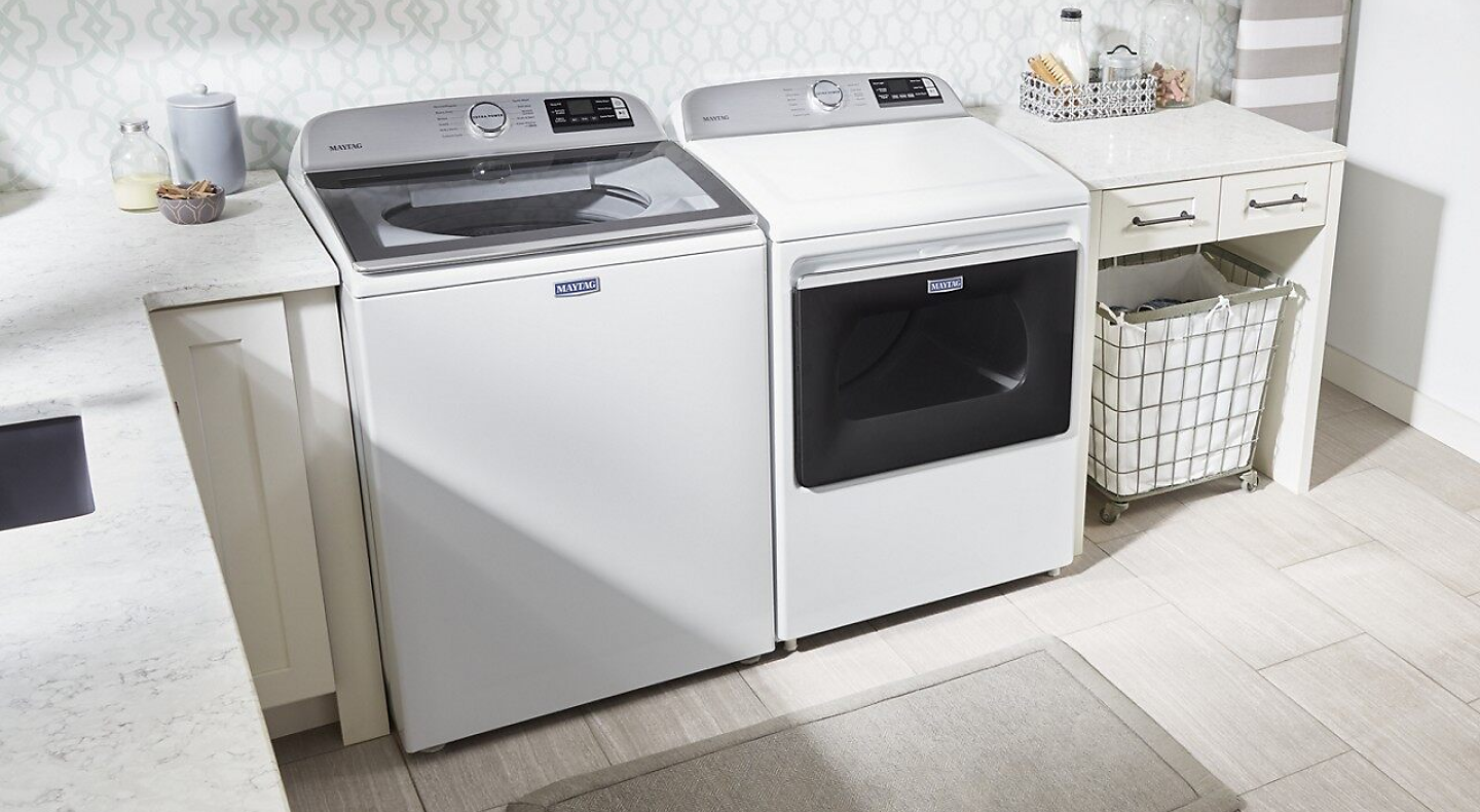 White top load Maytag® washer and dryer pair in laundry room