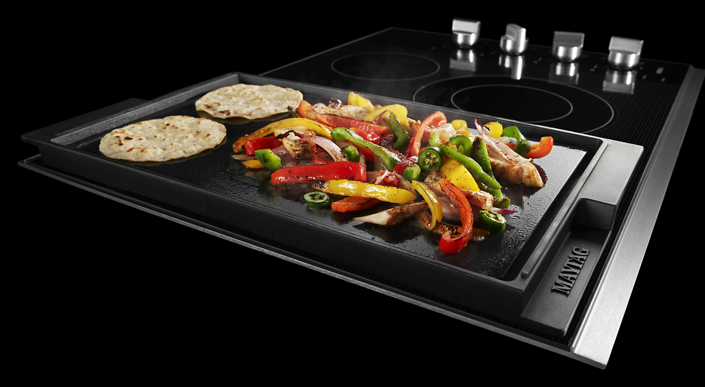 Vegetables and tortillas cooking on a Maytag® griddle