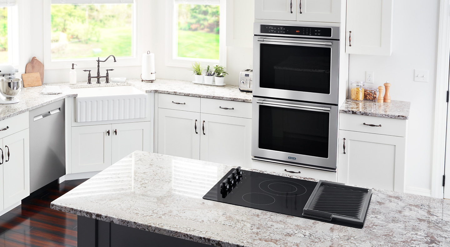 Maytag® cooktop and double wall oven in a bright kitchen
