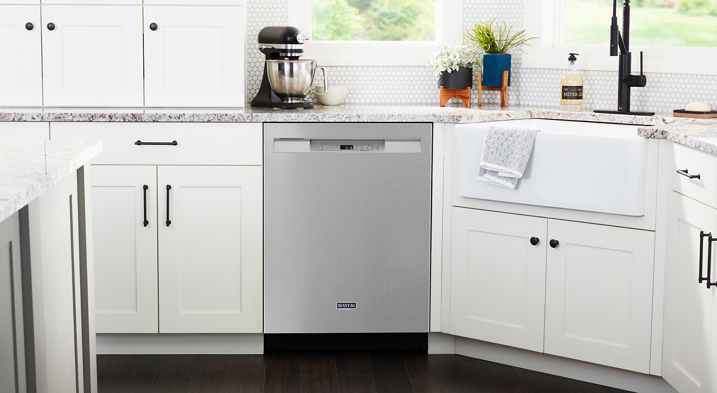 Maytag® dishwasher set in a white cabinetry.