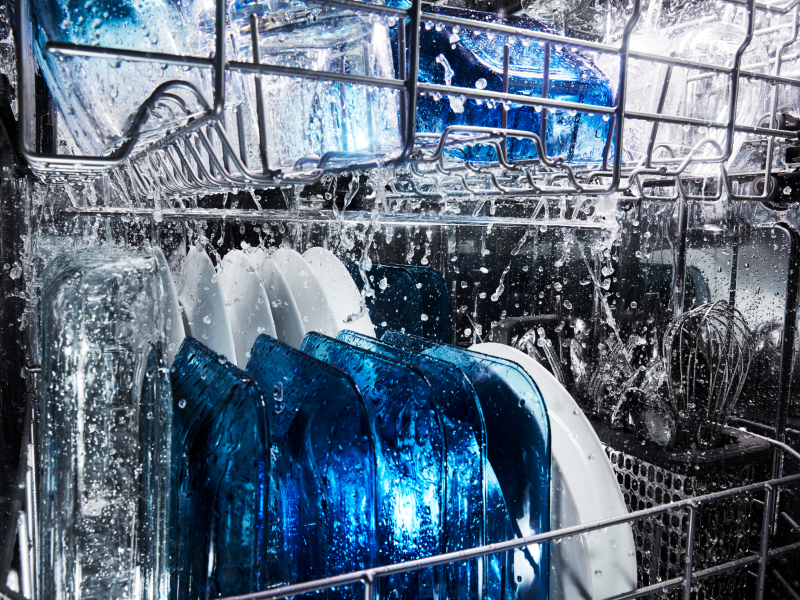 Water running on dishes in a dishwasher.