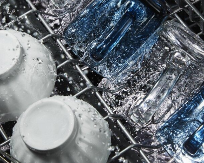 Water running over dishes in dishwasher