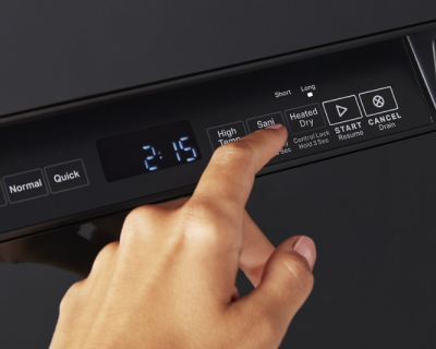 Person choosing cycle on black dishwasher