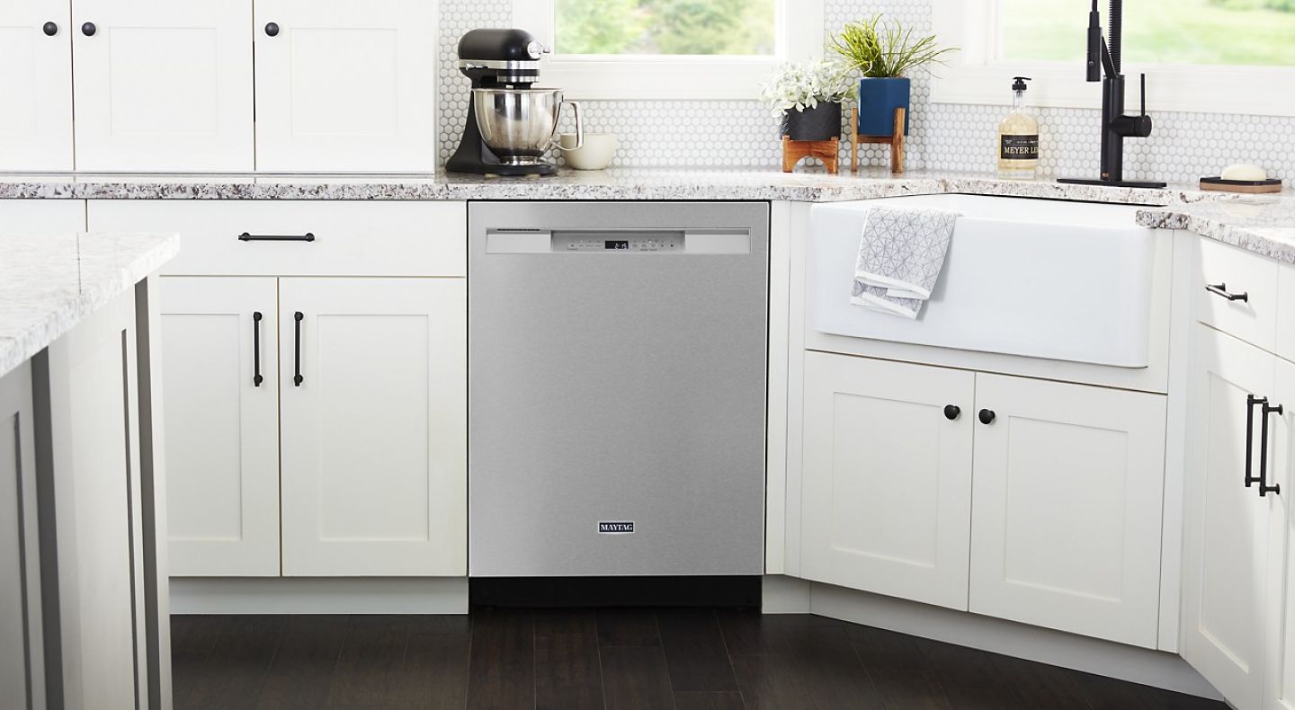 Stainless steel Maytag® dishwasher set in white cabinetry