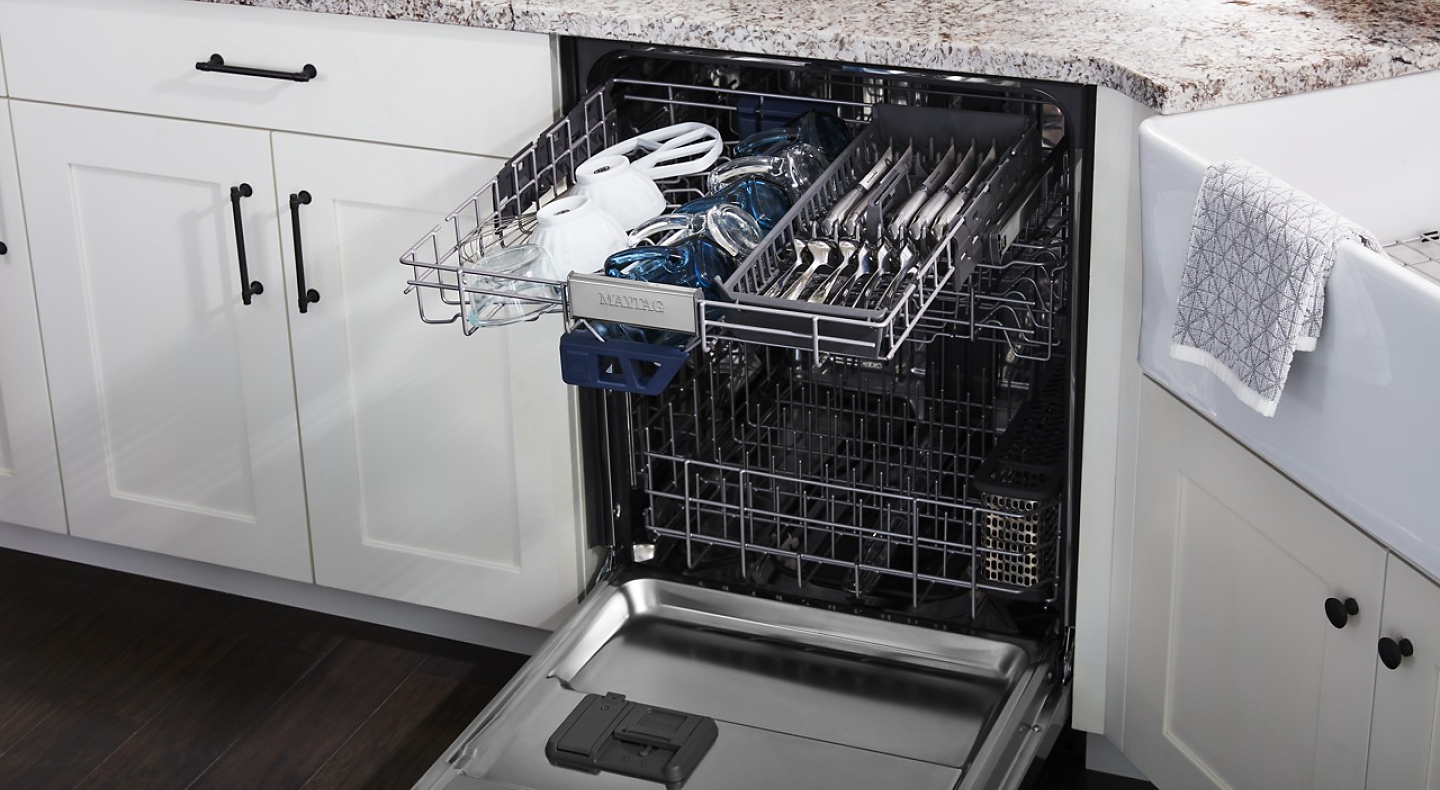 Stainless steel Maytag® dishwasher open with top rack pulled out