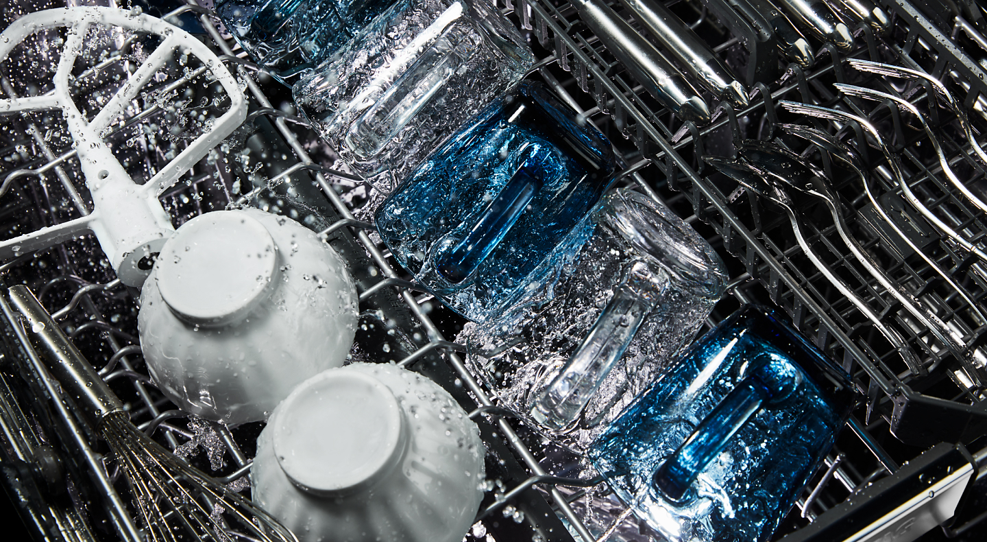 Dishes being washed inside a dishwasher