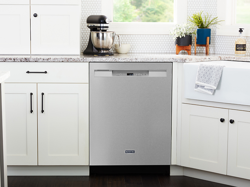 Maytag® stainless steel dishwasher in white cabinetry