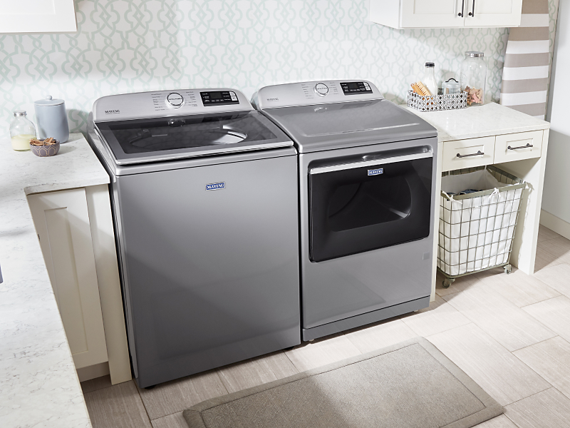 A washer and dryer pair by Maytag brand in a modern laundry room