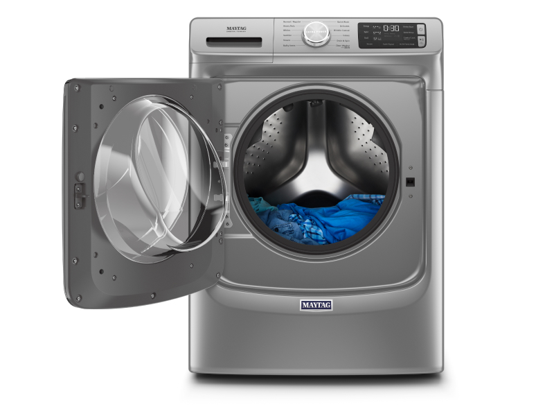 A front view of laundry in an open Maytag® Front Load Washer