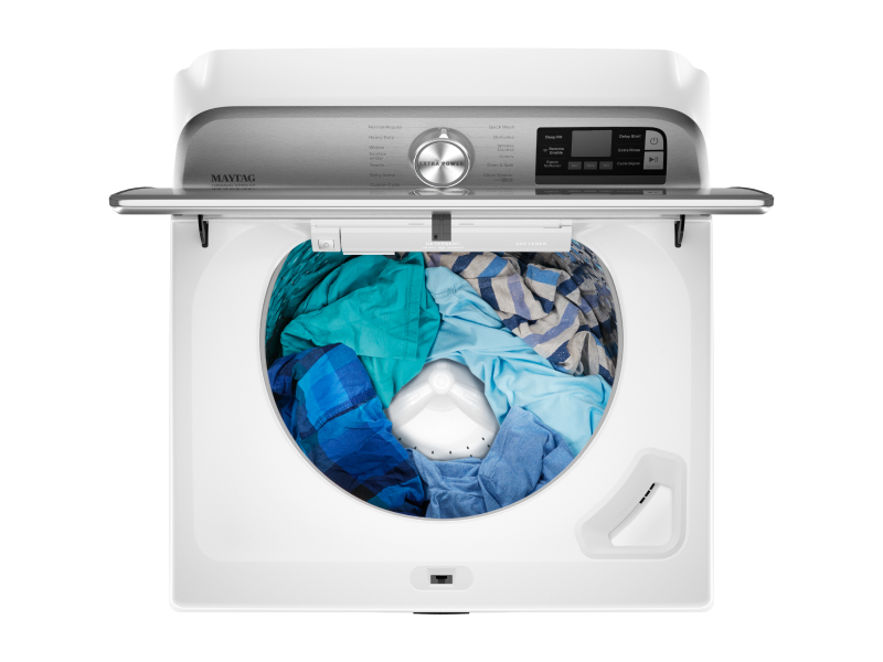 A top view of laundry in an open Maytag® Top Load Washer