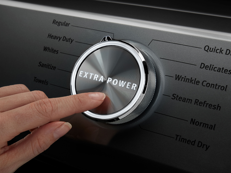 A person pressing the Extra Power button on a Maytag® dryer.