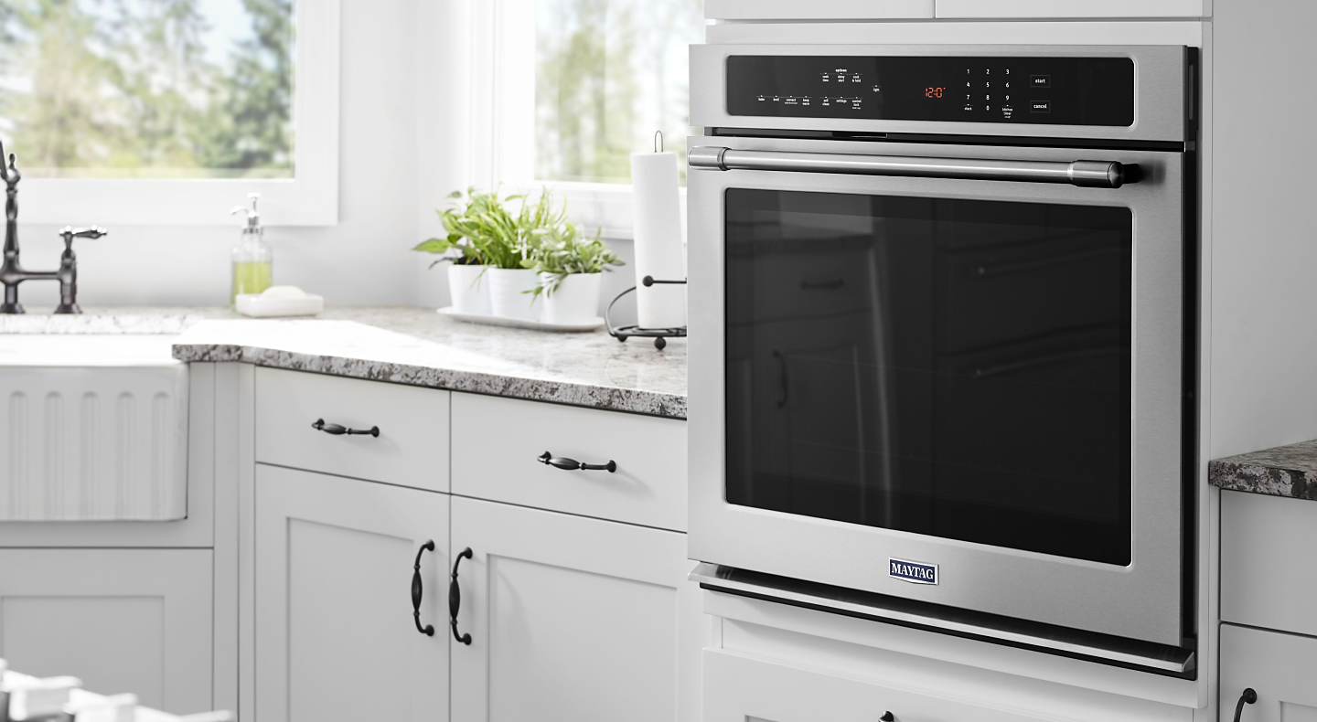 Close-up of a Maytag® wall oven in a bright kitchen