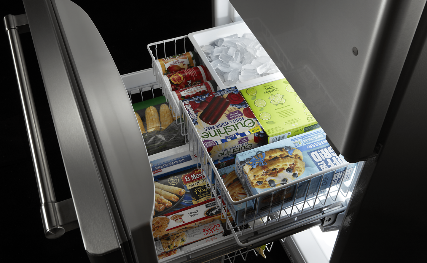 Open drawer freezer with pull-out basket full of frozen food