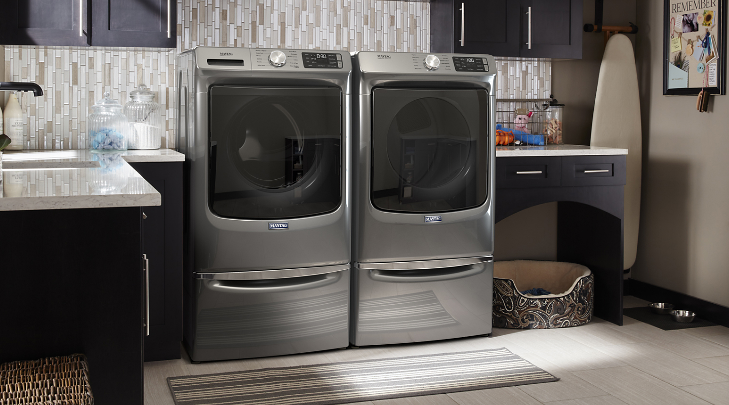 Maytag® front-loading washer and dryer in a laundry room