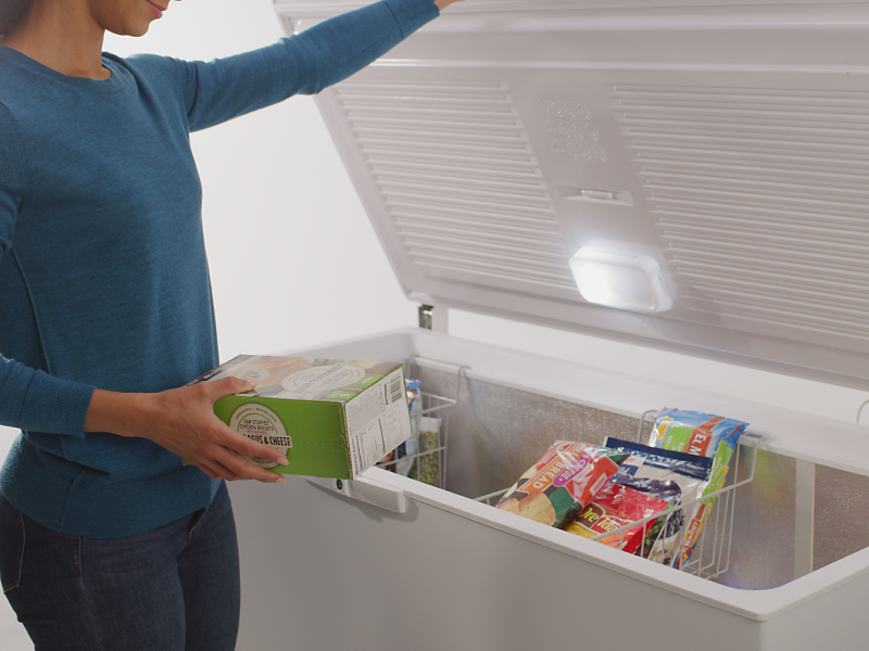 Person placing food in a freezer