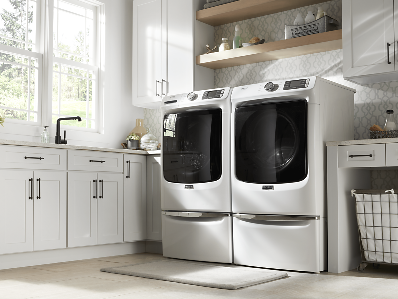 White front-load washer and dryer in modern laundry room
